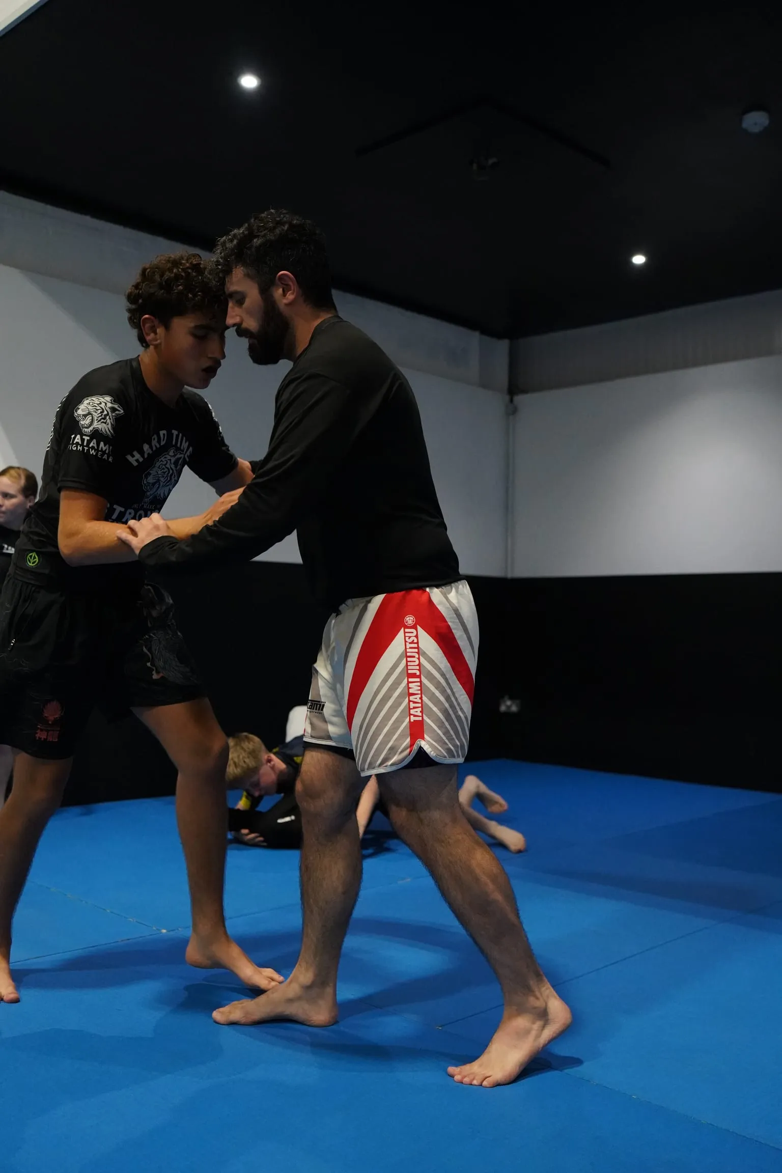 Two grapplers hand-fighting on their feet during a no-gi class at Rebel Combat Sports