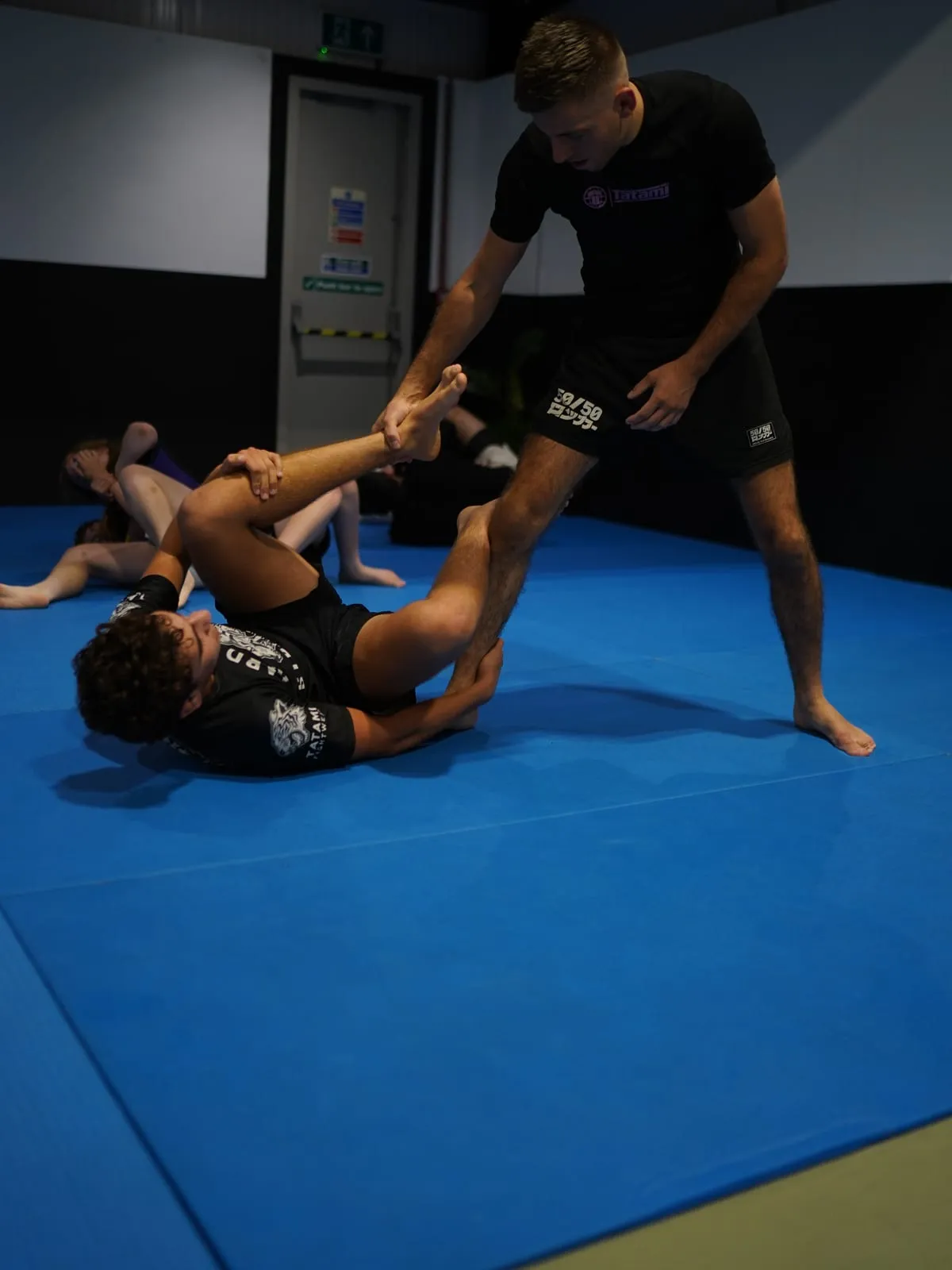 Charlie working a standing pass against a training partner's open guard