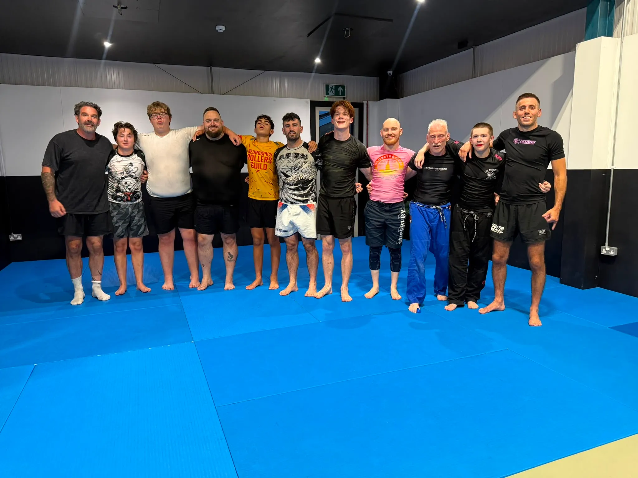 Rebel members — gi and no-gi together — lined up on the mats after a session in launch week
