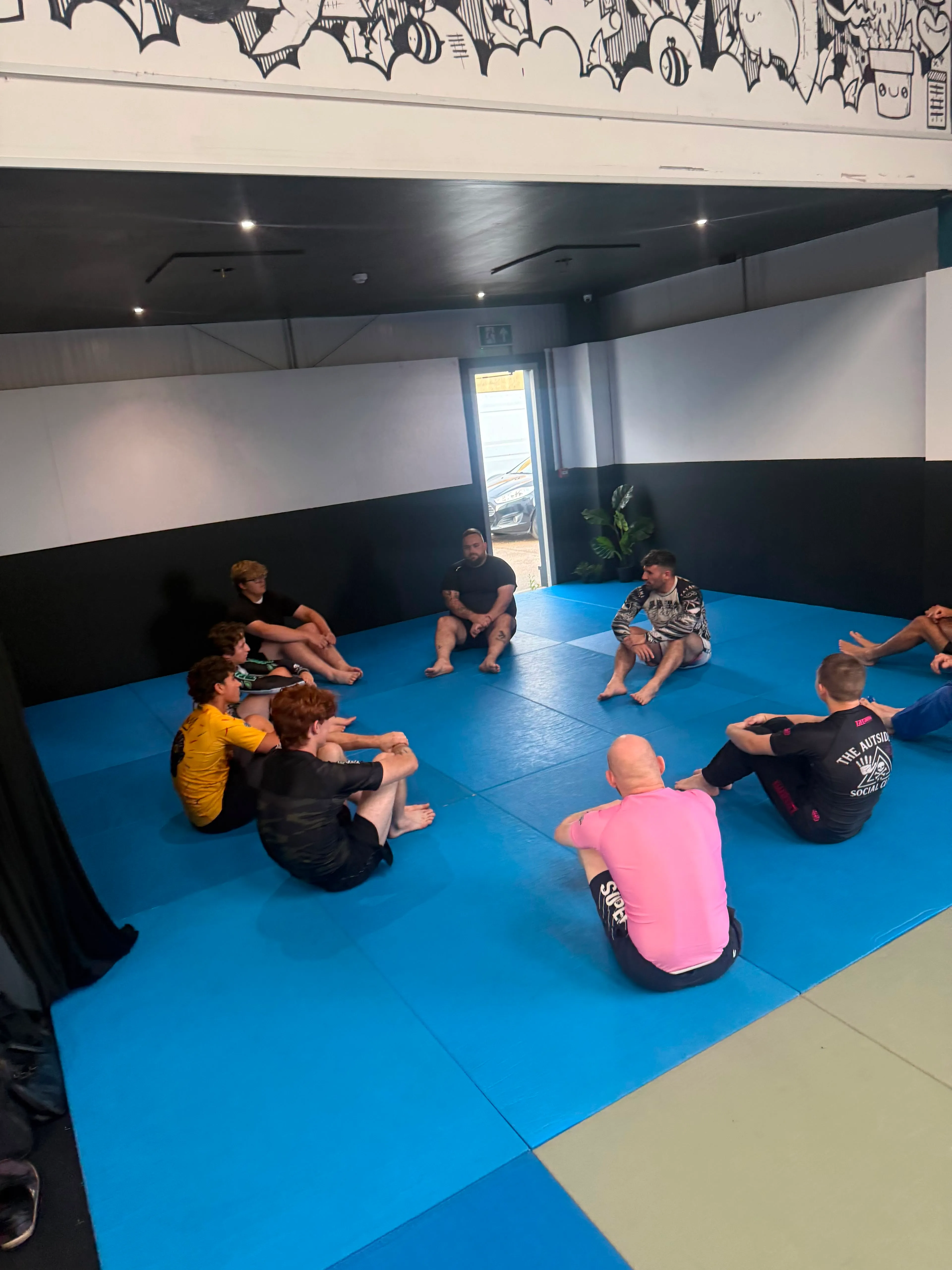 Members sat in a circle on the mats, talking questions through