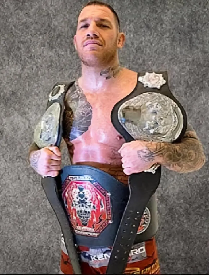Tolly Plested with three MMA title belts